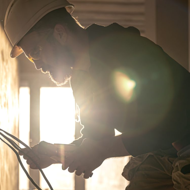 worker-is-cutting-wires-with-lineman-s-pliers